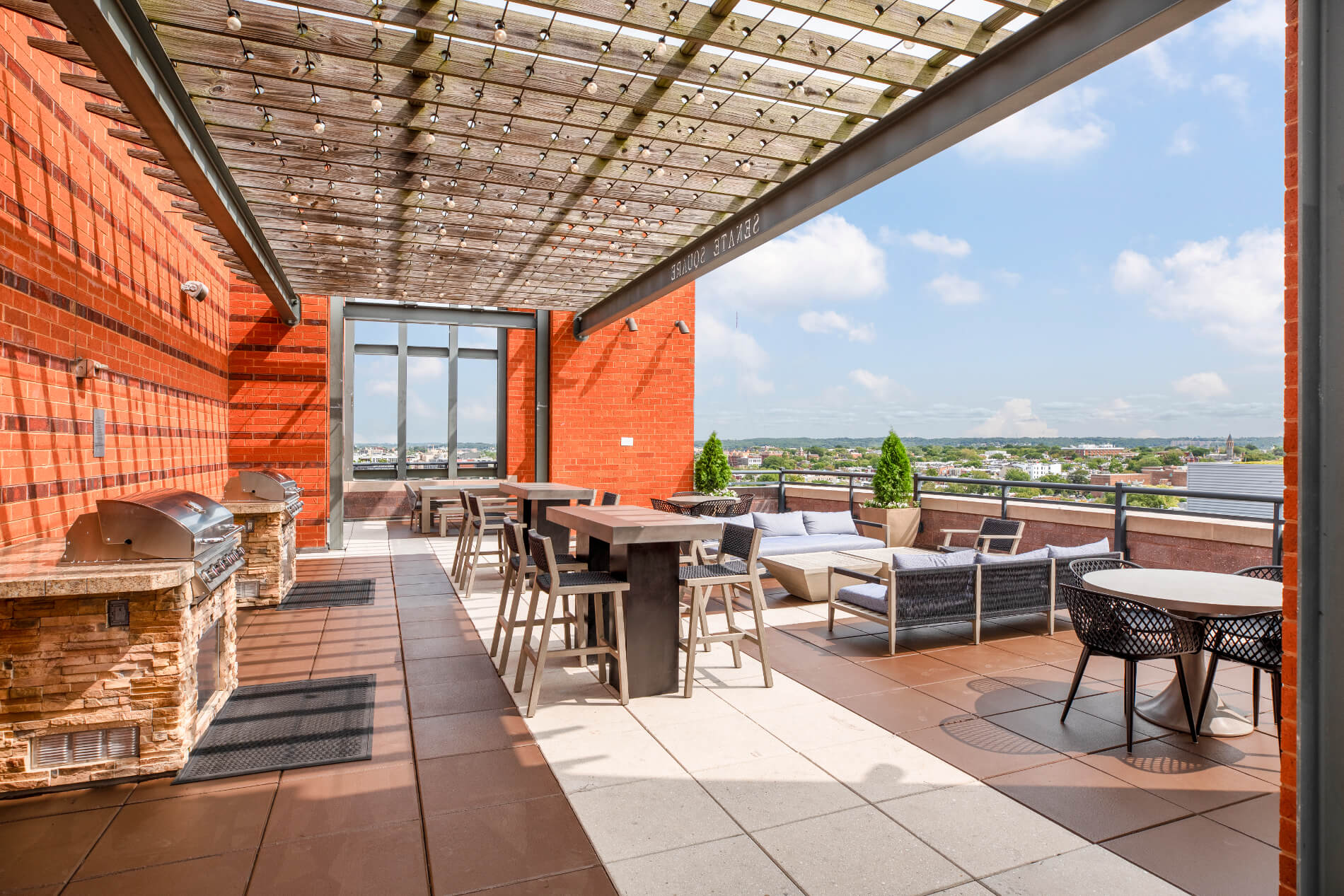 Grilling stations with a variety of tables and chairs overlooking the city