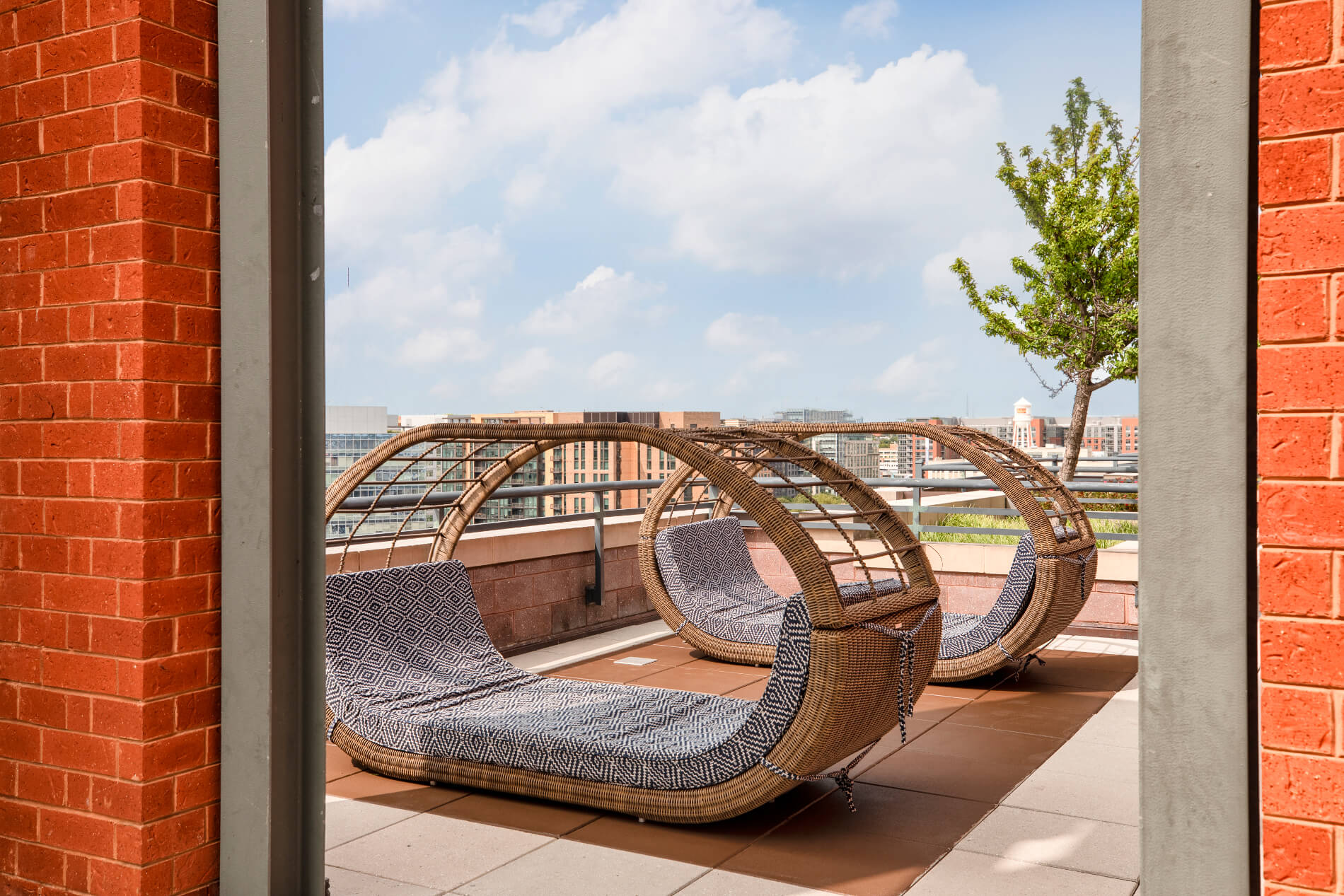Rooftop wicker chairs in the shape of pods with large cushions