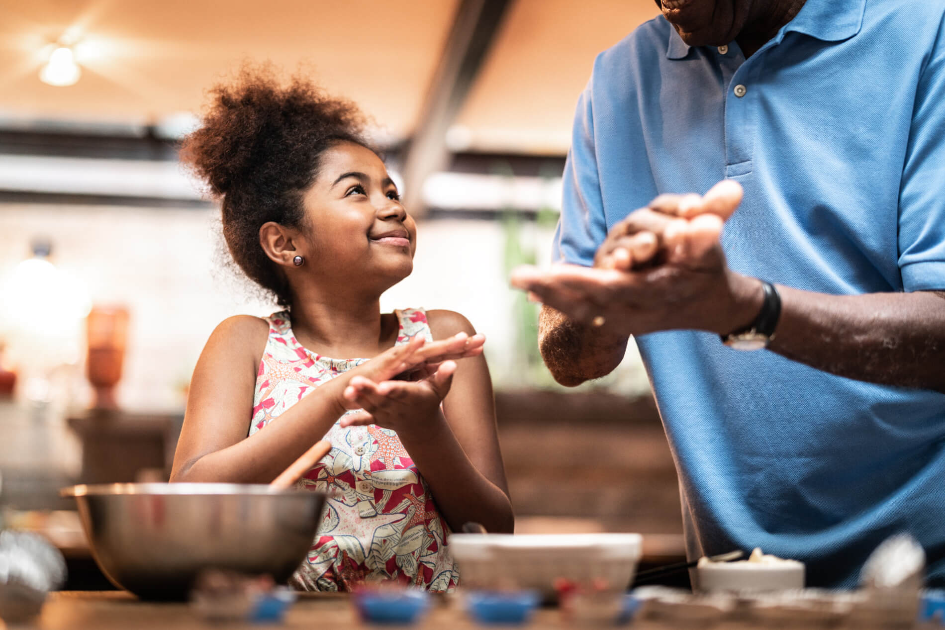Young girl with dad baking cookies in social lounge