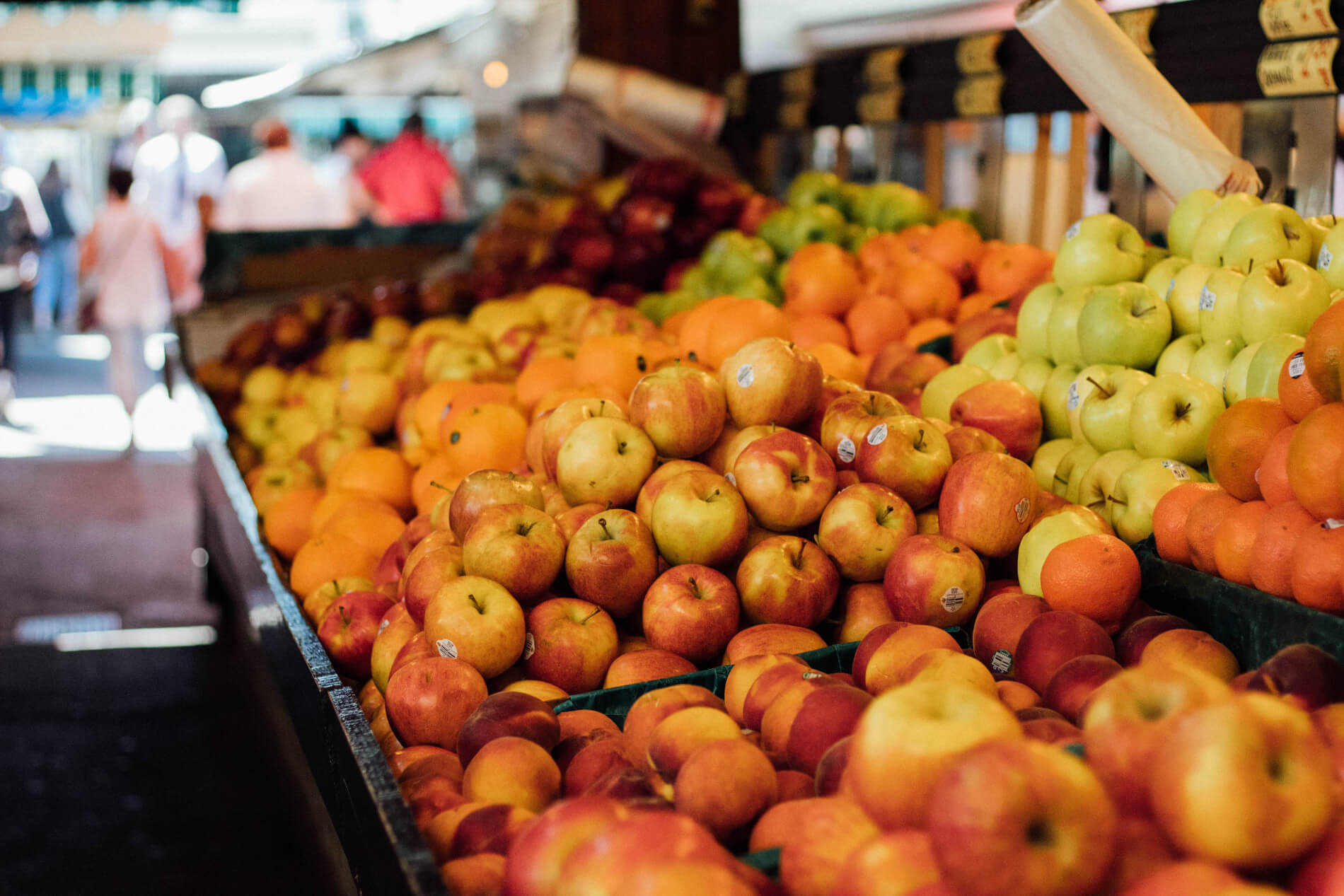 Giant grocery store showing apples and other fruits with shoppers in background